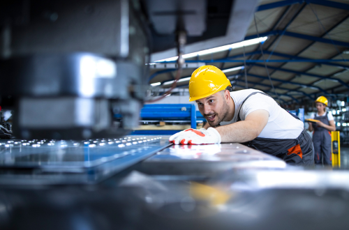 factory-worker-protective-uniform-hardhat-operating-industrial-machine-production-line