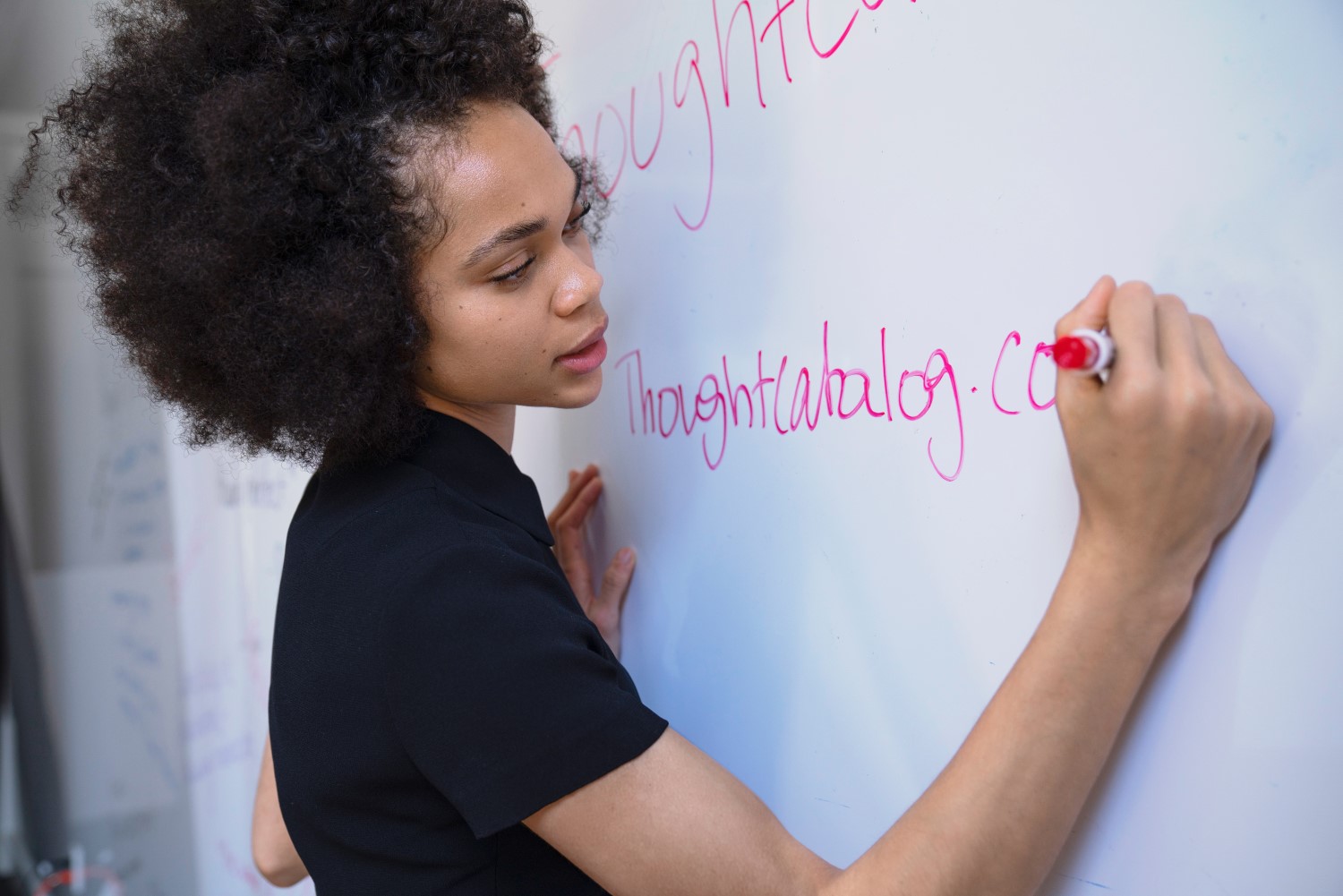 Lady writing on a whiteboard