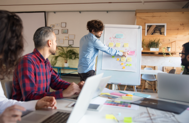 Person Giving Presentation and pointing at a whiteboard