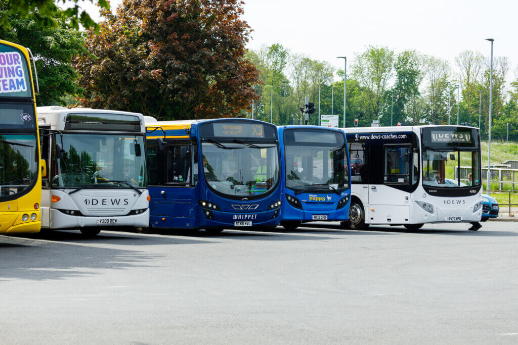 row of buses at a bus depot in Cambridgeshire and Peterborough