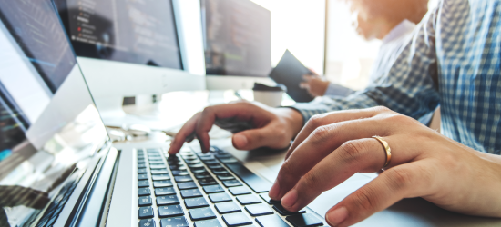 Person typing on a laptop keyboard