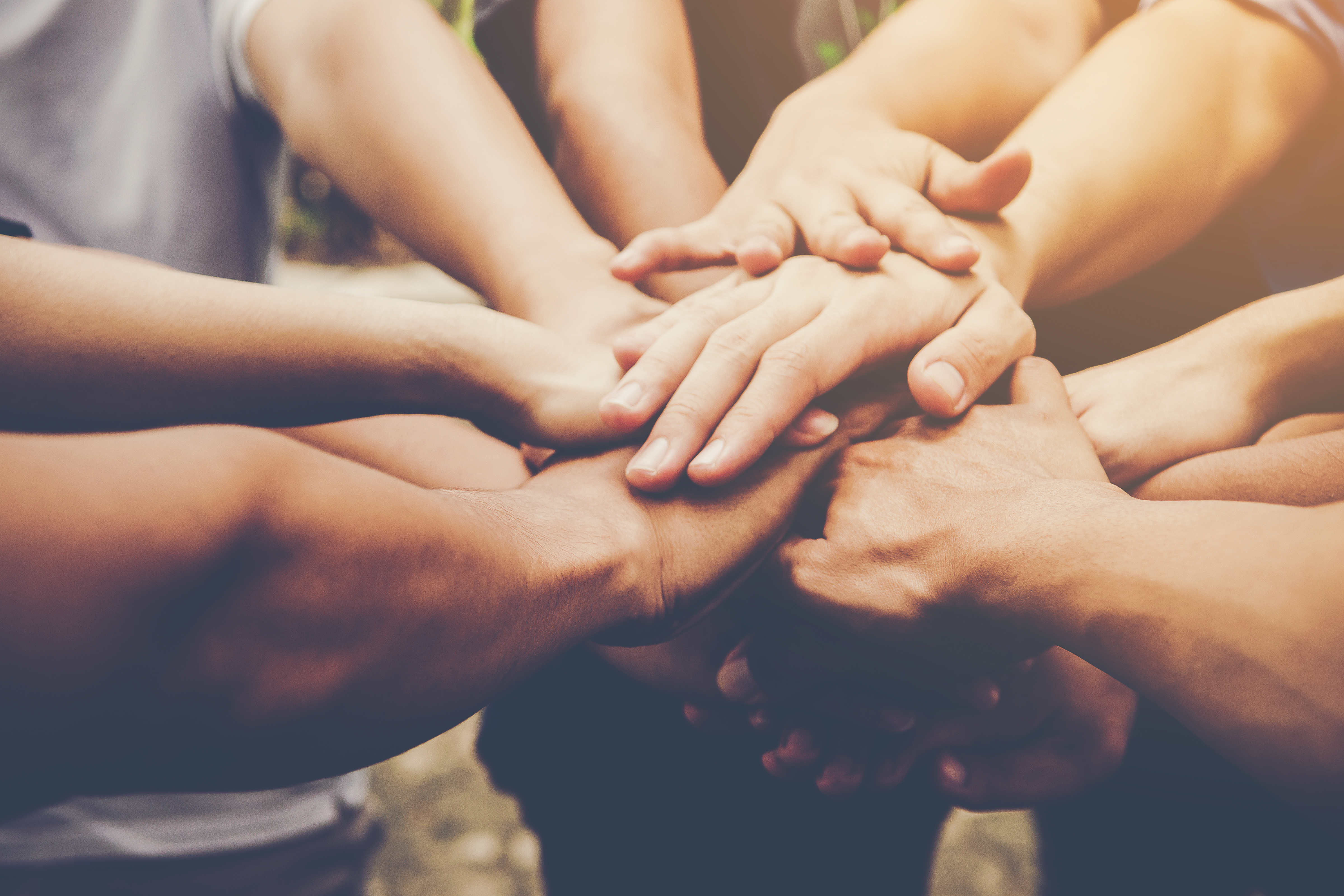 Peoples hands in a circle