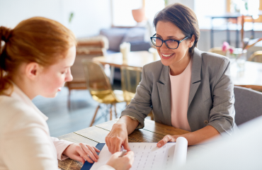 Smiling teacher sitting with a Student